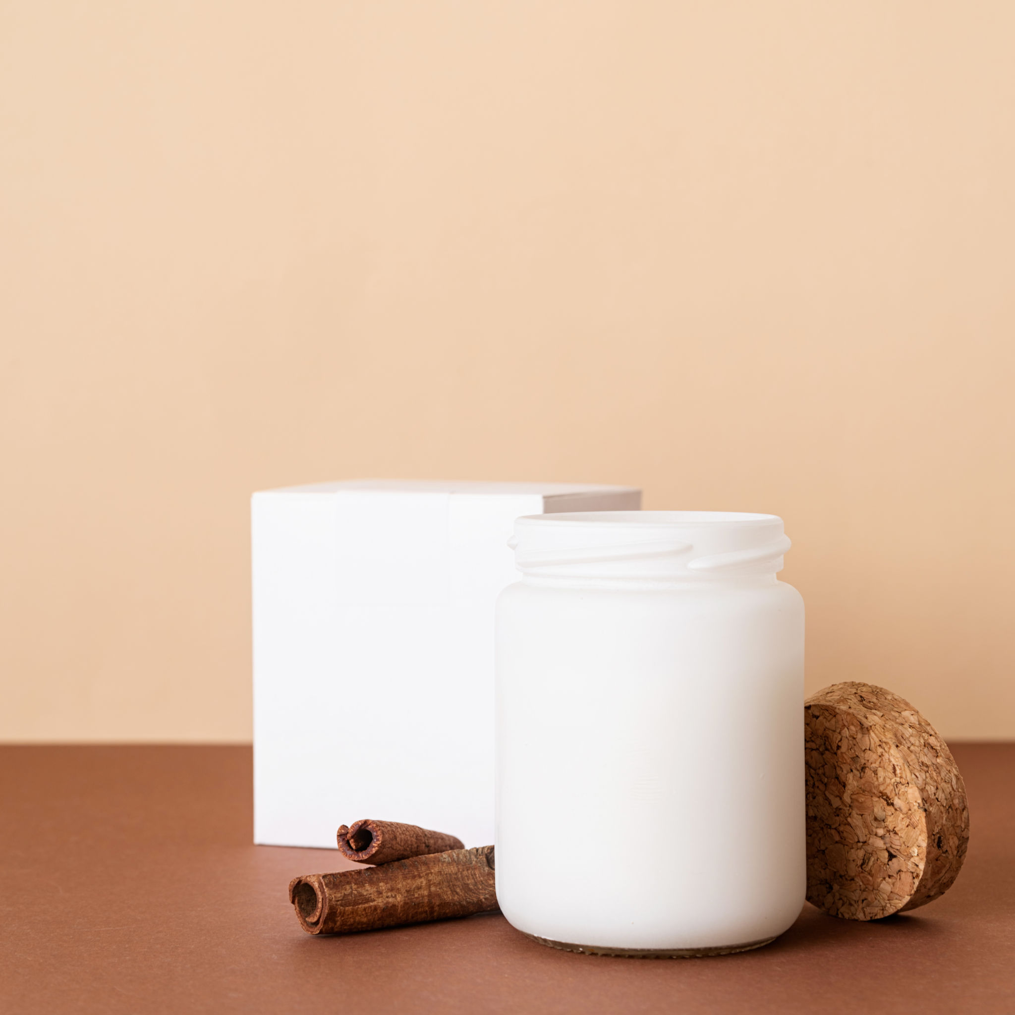 Scented soy candle in a festive jar with warm styling on a clean white background
